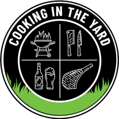 A circular emblem with Cooking in the Yard written on top. The emblem is divided into four quadrants with icons: a grill, kitchen knives, a bottle and glass, and a meat cut. Green grass lines the bottom edge.