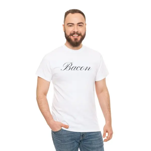 A man with a beard, perfectly smiling and standing in blue jeans and a Bacon T-shirt against a crisp white background.