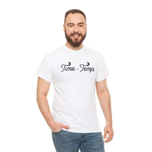 A bearded man stands smiling in a white t-shirt that features the "Time & Temp Tee" design and pairs it with blue jeans, achieving an ideal casual look against a plain white background.