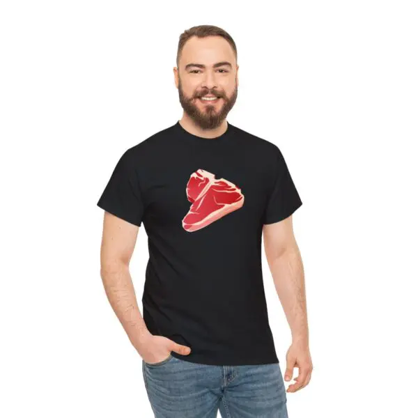 A bearded man is smiling while wearing the "Steak T Shirt," which features a graphic of a delicious red steak. He is standing against a plain white background.