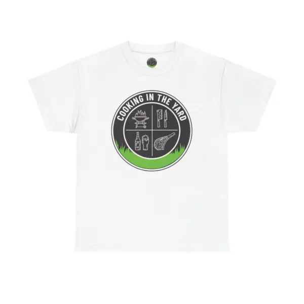 Cooking In The Yard T-Shirt: A white tee featuring a round black and green logo in the center. The design includes the text "COOKING IN THE YARD" alongside images of a grill, tongs, a bottle, a steak, and a spatula—ideal for enjoying those simple and delicious backyard BBQ moments.