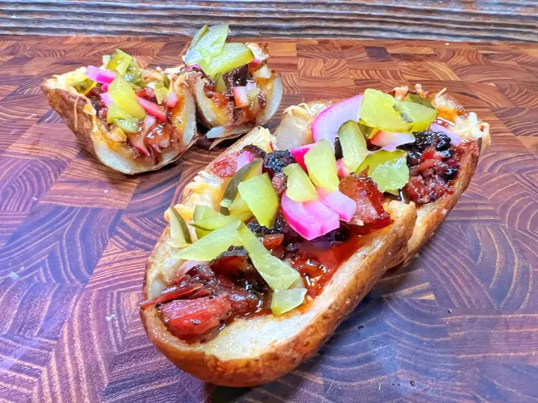 loaded brisket baked potato skins filled with leftover brisket, bbq sauce, cheese cheese, pickles and red onions.