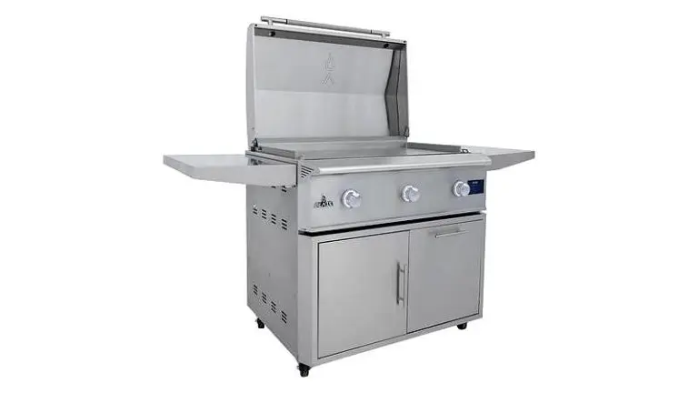 A stainless steel outdoor gas grill with three control knobs, two side shelves, a large cooking surface with the lid open, and a double-door storage cabinet below—perfect for your Blaze Griddle Giveaway or outdoor cooking needs.