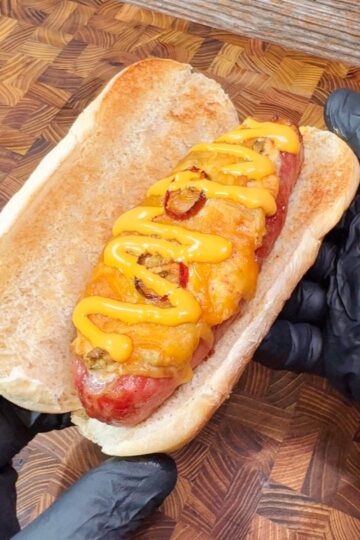 jalapeno popper stuffed bratwurst covered with cheese and sauce.