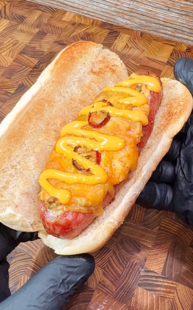 jalapeno popper stuffed bratwurst covered with cheese and sauce.