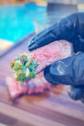 close up of a piece of steak with jalapeno chimichurri on it.