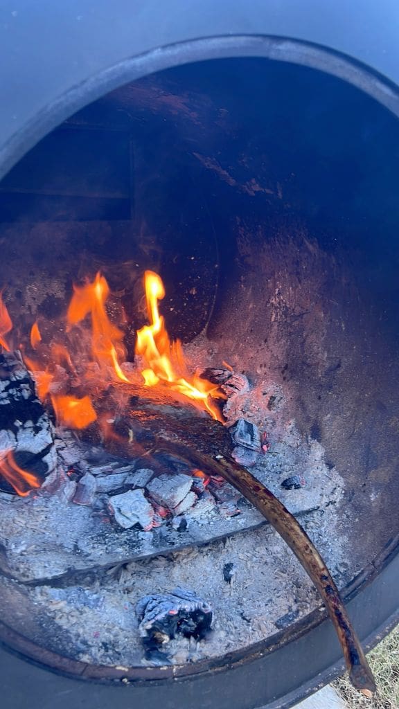 Reverse searing a tomahawk directly over coals in smoker box before serving.