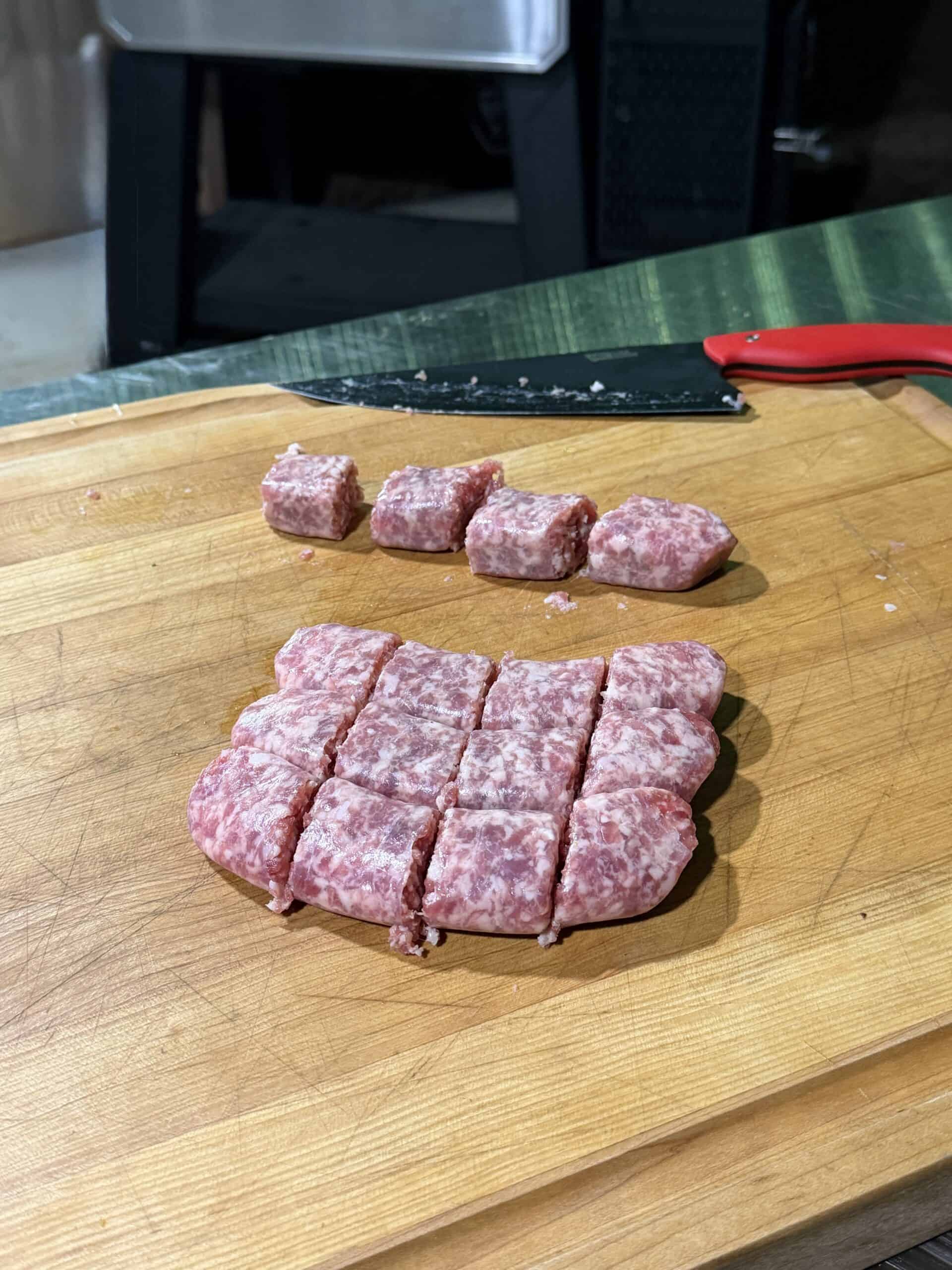 A cutting board with delicious Bacon Wrapped Brat Bites arranged on it.