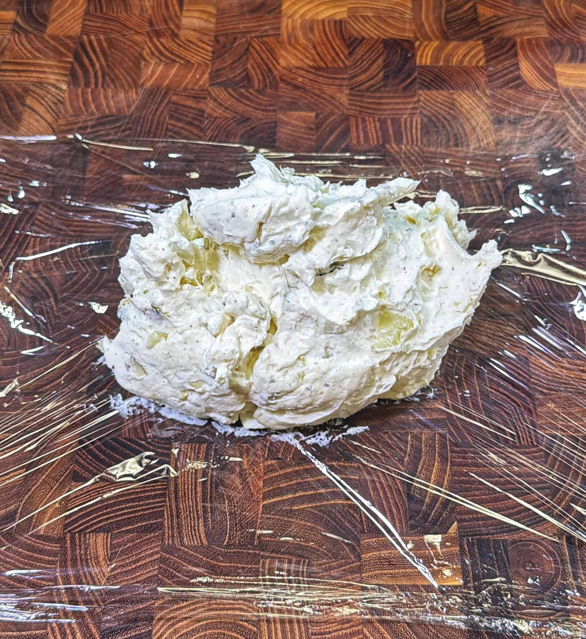 A ball of butter on a plastic wrap.