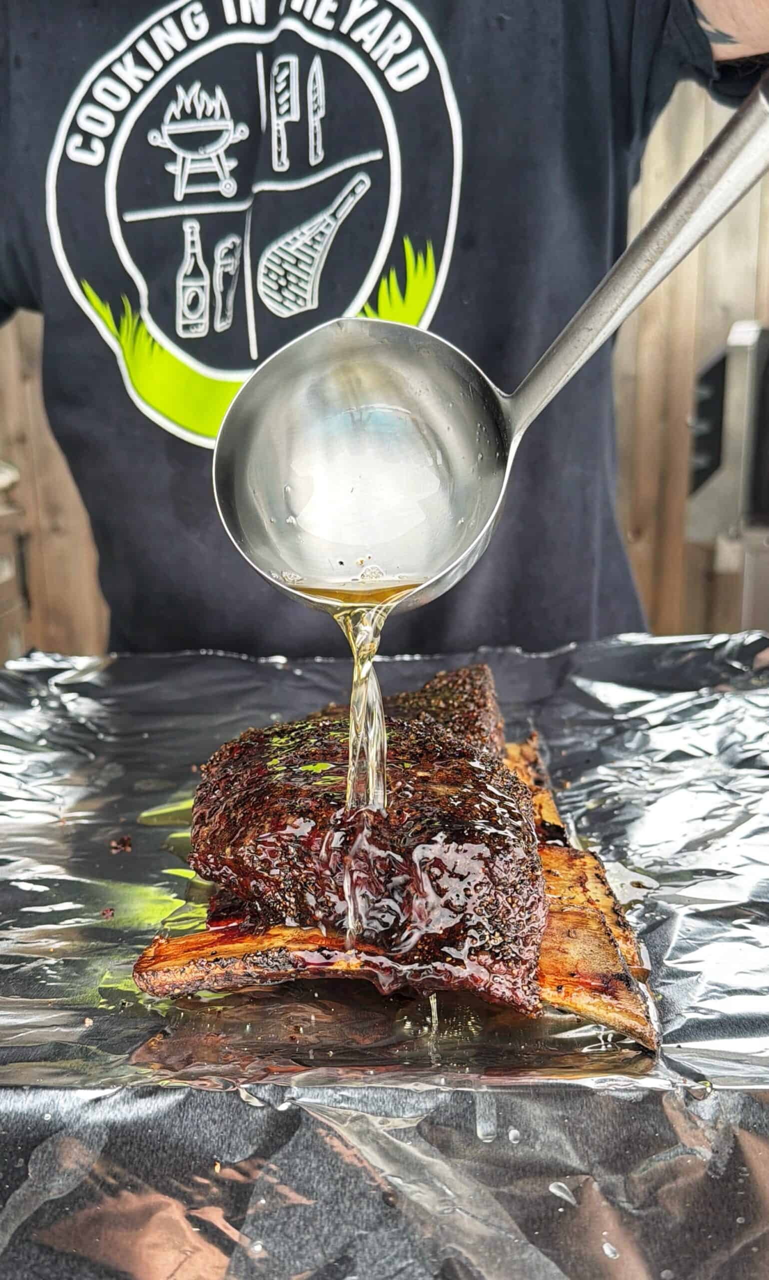 Reynolds Wrap Everyday Strength Aluminum Foil Roll, 12 Inch Wide, 200sq ft on Amazon A person pours liquid from a ladle over glazed, seasoned beef ribs resting on <a href=