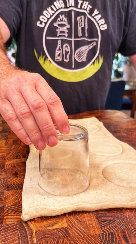 Mini pepperoni pizzas being prepared