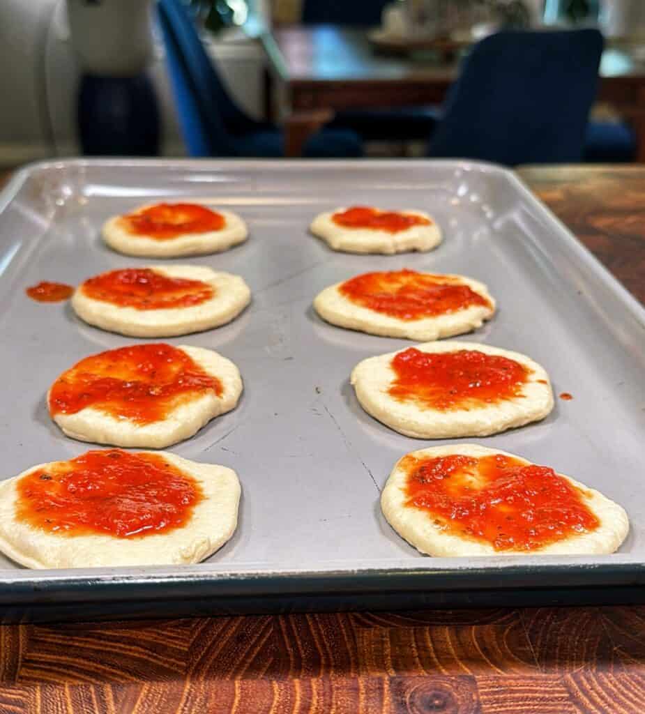 Mini pepperoni pizzas being prepared