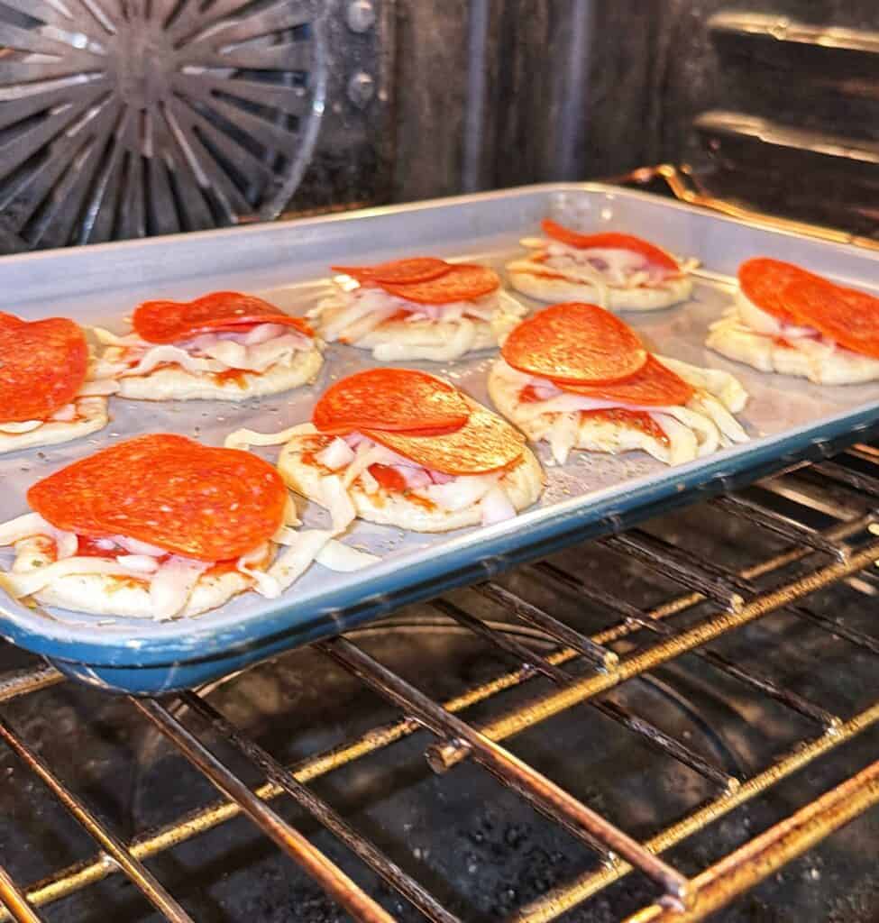 Mini pepperoni pizzas being prepared