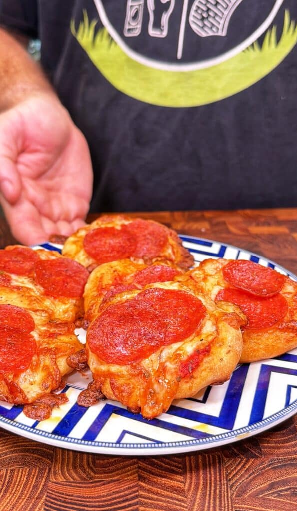 Mini pepperoni pizzas being prepared