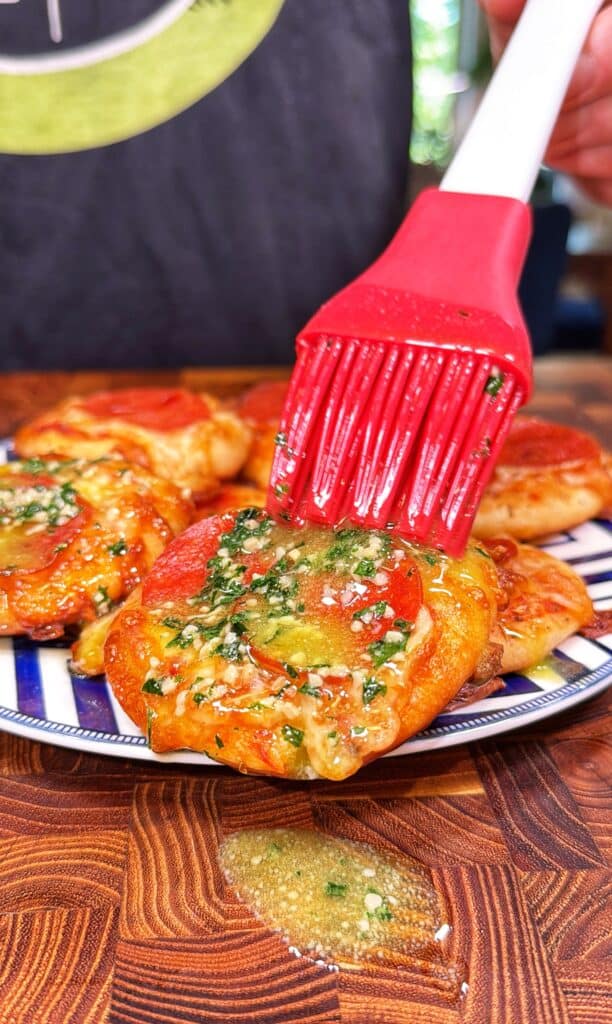 Mini pepperoni pizzas being prepared