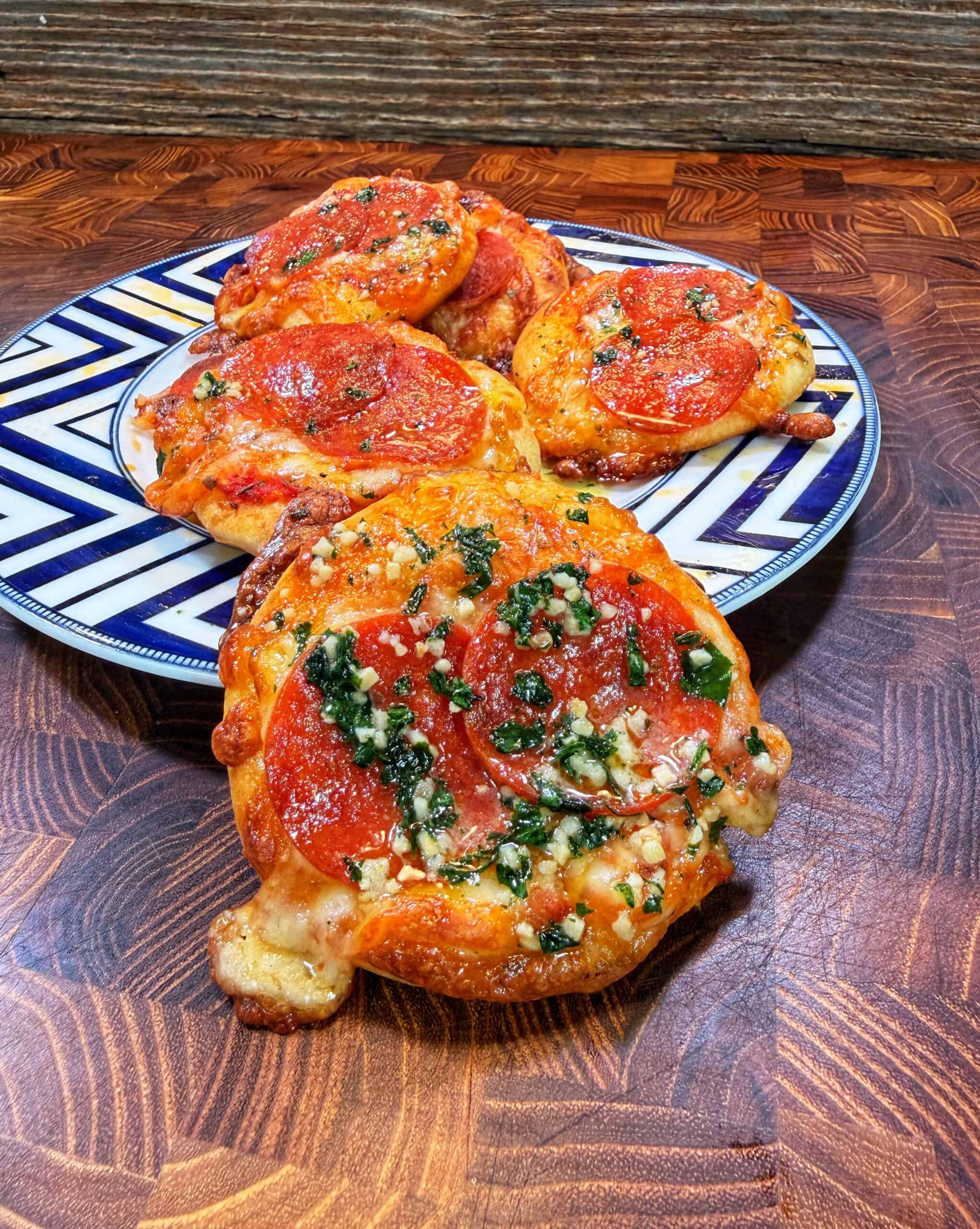 Mini pepperoni pizzas being prepared