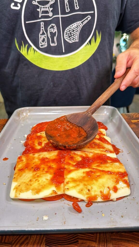 Upside-down sheet pan pizza being prepared.