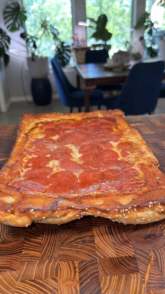 Upside-down sheet pan pizza being prepared.